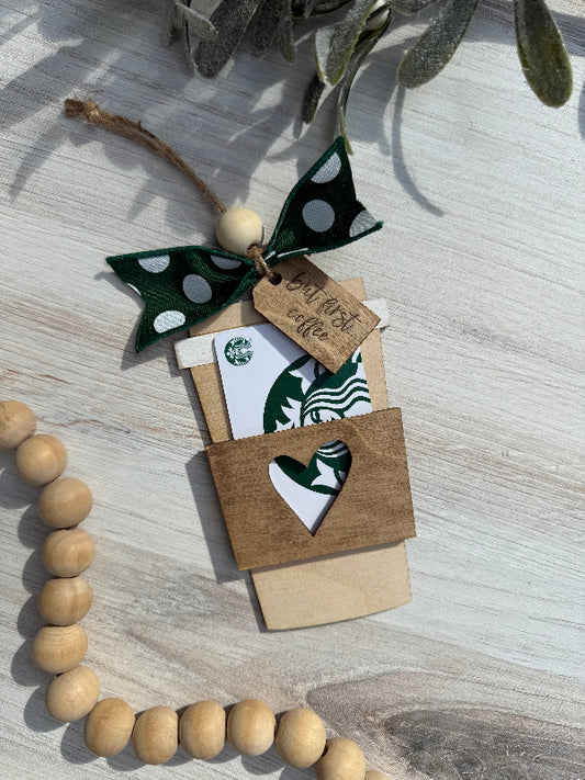 Coffee Cup shaped Gift card holder with decorative bow and wooden beads on a light surface.