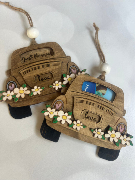 Wooden car-shaped ornaments with floral decorations on a white background