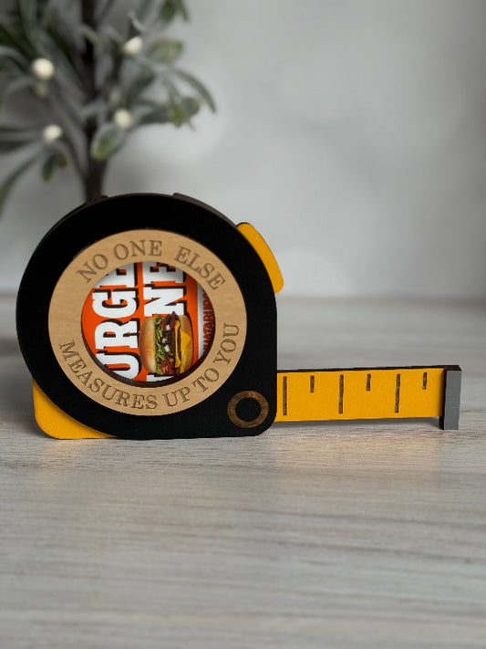 Tape measure with a branded logo on a wooden surface