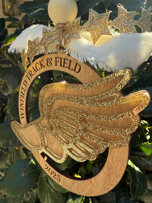 Wooden ornament with 'Winfield Track & Field' and '2023' on a Christmas tree.