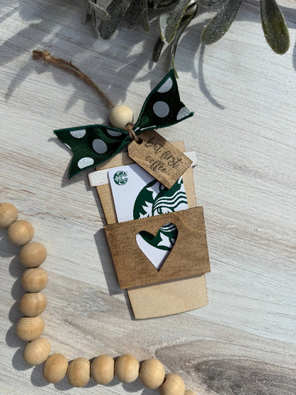Coffee Cup shaped Gift card holder with decorative bow and wooden beads on a light surface.