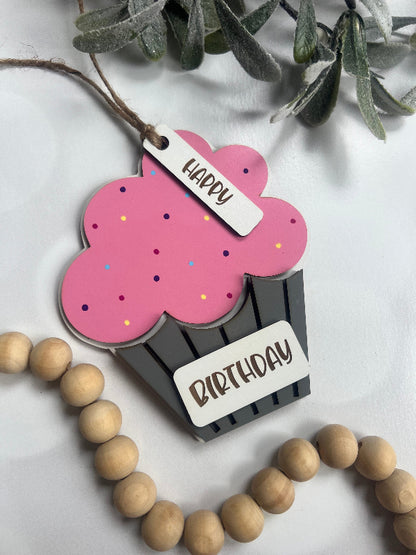 Decorative gift card holder with pink cupcake design an painted sprinkles beads on a light background