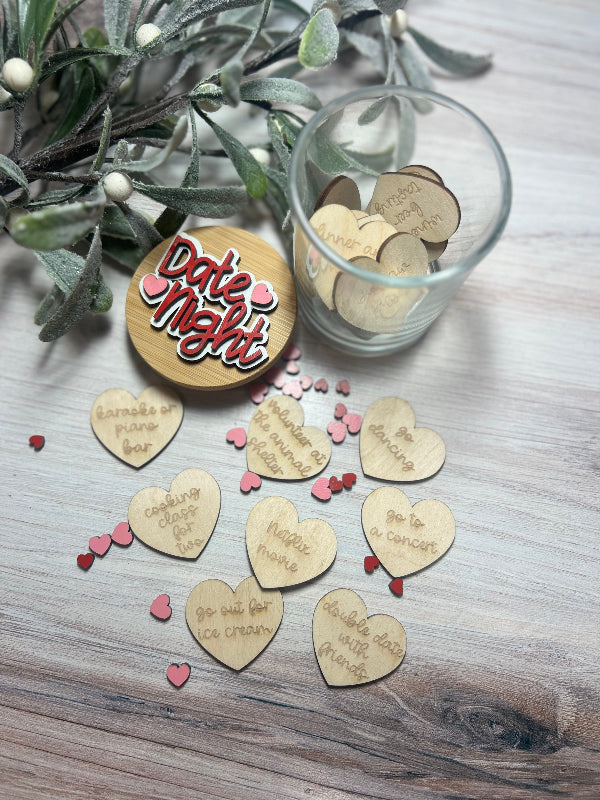 Wooden heart-shaped tokens with date ideas on a wooden surface with a glass container.