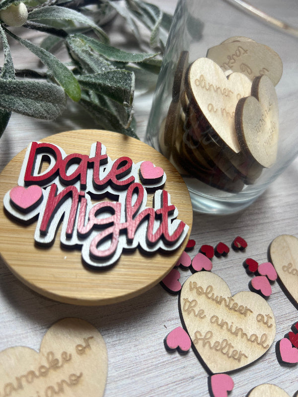 Wooden jar lid with 'Date Night' text and hearts, surrounded by decorative heart pieces engraved with date night ideas.