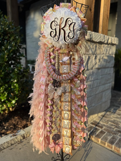 Single Deluxe Homecoming Mum in champagne, soft pink and ivory.  Custom monogram and braids