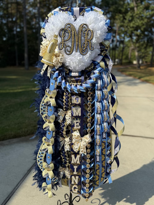 Decorative homecoming mum with navy, Columbia blue, white and gold ribbons.  Lake Creek High School.