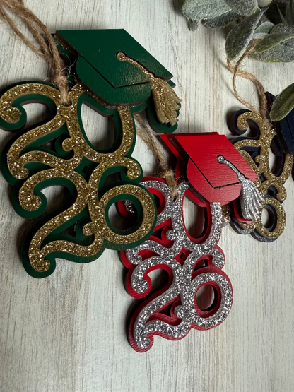 Decorative ornaments with graduation caps and numbers on a wooden surface