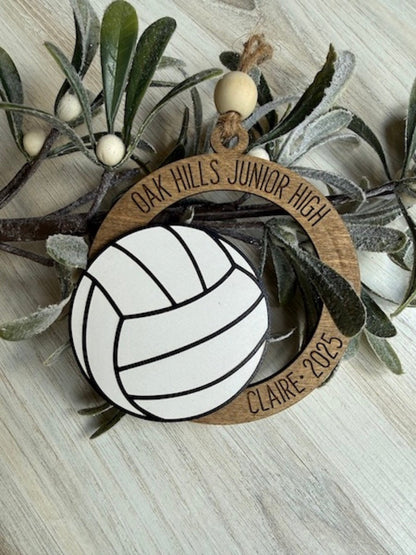 Decorative ornament with volleyball design and 'Oak Hills Junior High' text on a wooden tag.