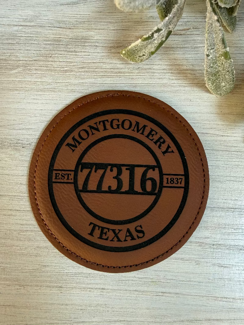 Brown leather coaster with engraved text on a leatherette surface