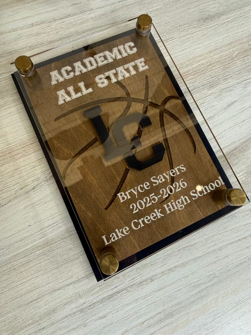 Academic All State plaque with engraved text on a wooden surface