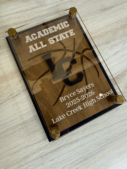 Academic All State plaque with engraved text on a wooden surface