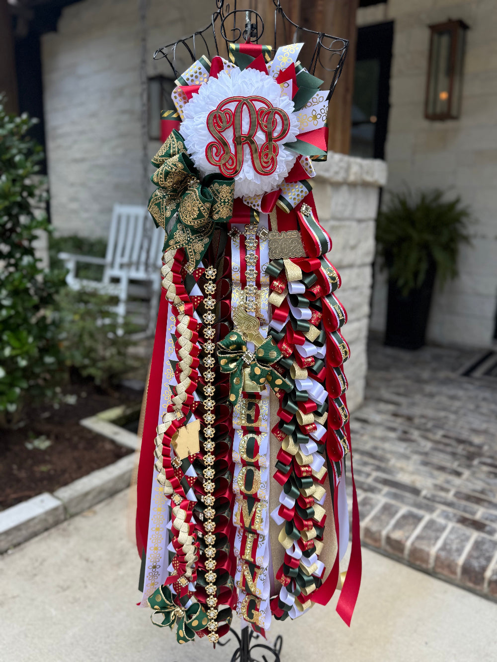 Single Homecoming Mum for The Woodlands High School in red, hunter green, white and gold.  Custom monogram and braids.