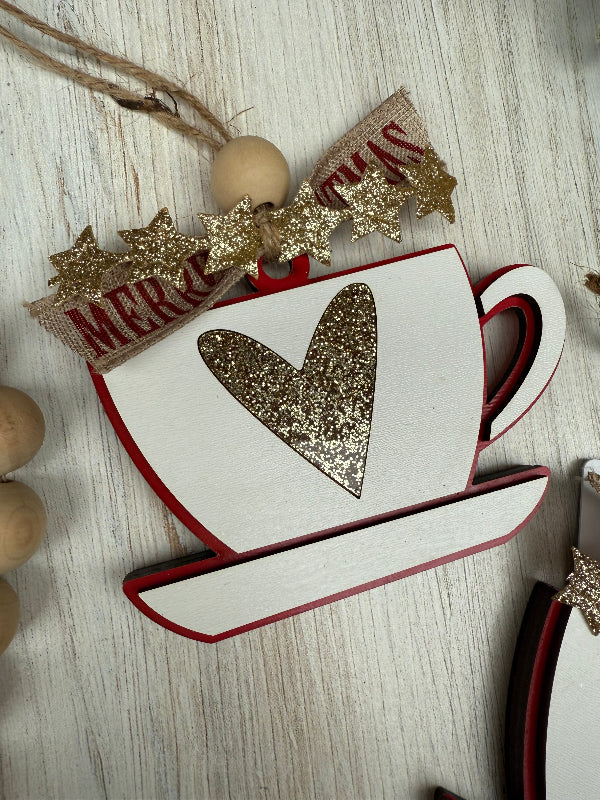 Decorative teacup ornament with a heart design on a wooden surface