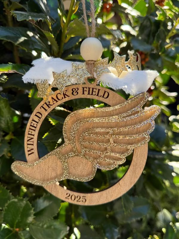 Personalized Ornament with a glittery track shoe outline.