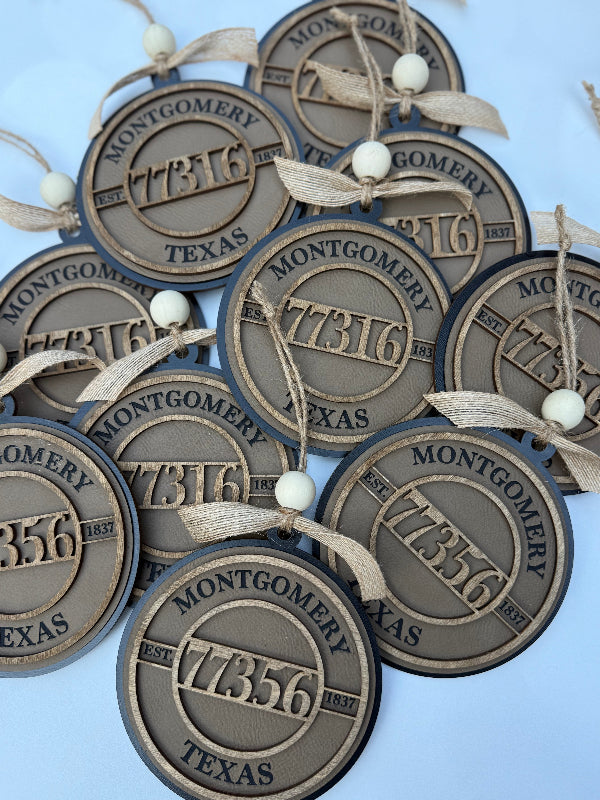 Decorative round ornaments with 'Montgomery, Texas' text on a light blue background